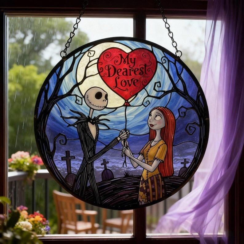 May include: Round stained glass window featuring Jack Skellington and Sally from The Nightmare Before Christmas. Jack holds a red heart-shaped balloon with the words "My Dearest Love". The background shows a graveyard and a full moon.