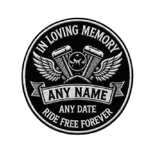 May include: A circular black and white patch with the text "IN LOVING MEMORY" and "RIDE FREE FOREVER". The patch features a motorcycle engine design with wings and space for a name and date.