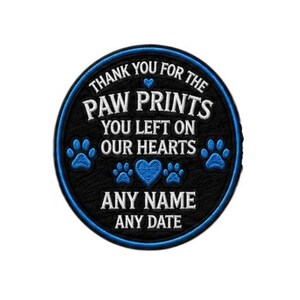 May include: A round, black patch with a blue border and text. The text reads "THANK YOU FOR THE PAW PRINTS YOU LEFT ON OUR HEARTS." Blue paw prints and hearts are also featured. The bottom of the patch says "ANY NAME ANY DATE."