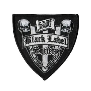 May include: Black Label Society patch with a shield shape. The patch is black with white embroidered text and graphics, including two skulls, a banner, and the words "Black Label Society".