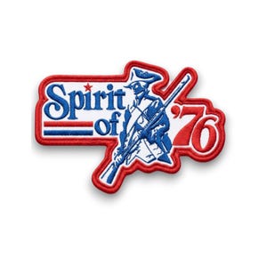 May include: Embroidered patch with a red border and the words "Spirit of '76" in blue and red. The patch features a blue and white illustration of a colonial soldier holding a rifle.