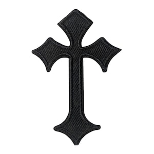 May include: A black embroidered patch in the shape of a cross with pointed, flared ends. The design features a thick, raised border and a textured, stitched surface throughout the entire cross shape, creating a uniform dark appearance.