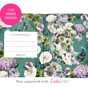 An open journal shows the inside cover with a peacock and floral design on a teal background, and a white "THIS JOURNAL BELONGS TO" label.