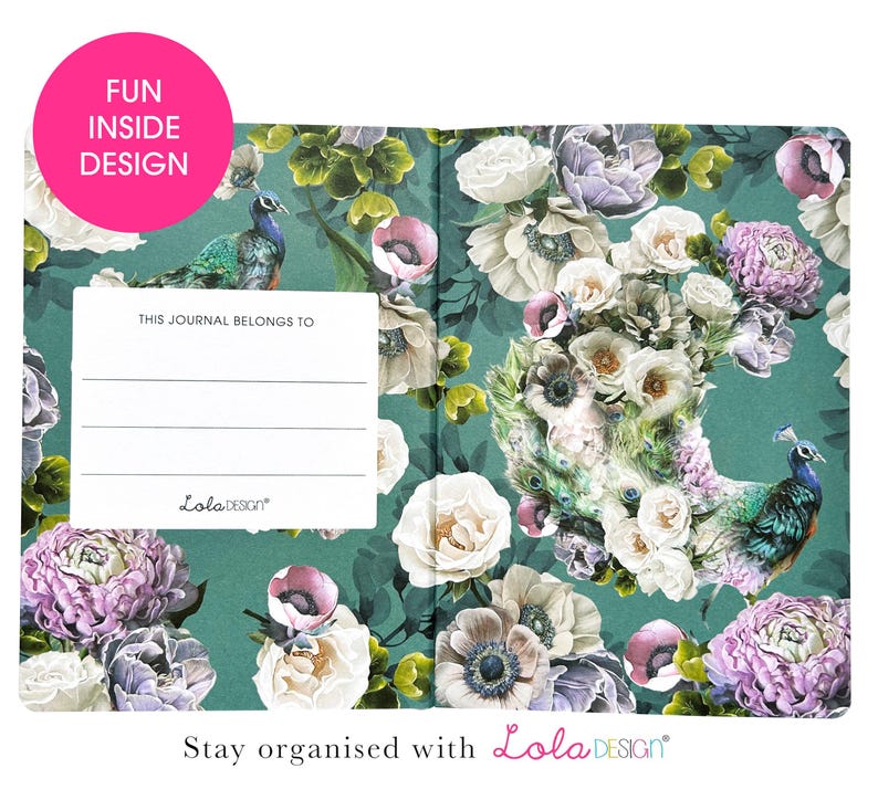 An open journal shows the inside cover with a peacock and floral design on a teal background, and a white "THIS JOURNAL BELONGS TO" label.