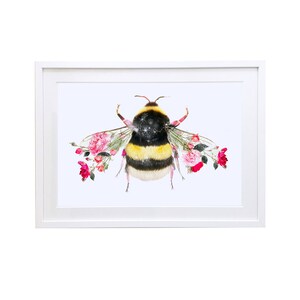 May include: A framed print of a bumblebee with pink roses forming its wings. The bumblebee is yellow and black with a white fuzzy body. The background is white.