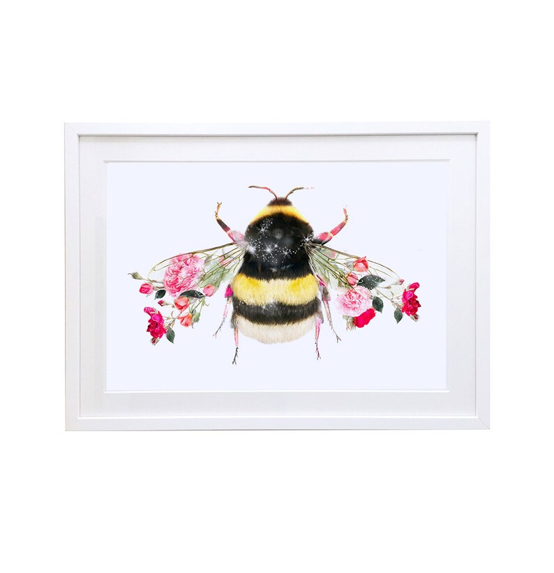 May include: A framed print of a bumblebee with pink roses forming its wings. The bumblebee is yellow and black with a white fuzzy body. The background is white.