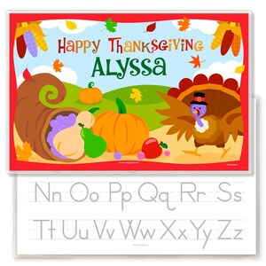 Thanksgiving Place with a turkey , cornucopia with vegetables and pumpkin, on a fall scene background. Reverse is alphabet with letters for tracing.