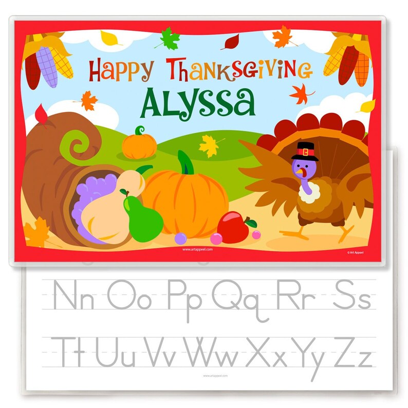 Thanksgiving Place with a turkey , cornucopia with vegetables and pumpkin, on a fall scene background. Reverse is alphabet with letters for tracing.