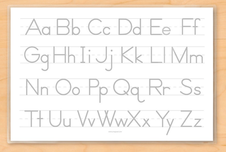 Image of back of place mat for kids with alphabet of upper and lower case grey letters on lines for tracing .