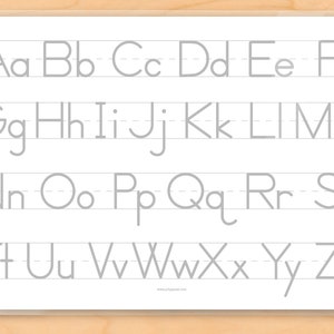 Image of back of place mat for kids with alphabet of upper and lower case grey letters on lines for tracing .