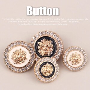 May include: Four round buttons featuring a central gold-tone lion head relief. Two buttons have a white background and two have a black background. Each button is encircled by a gold-tone rim embedded with clear crystals. The text Button is visible.