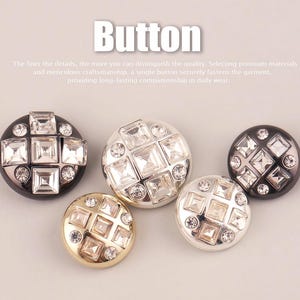 May include: Five round buttons featuring a grid of square and circular clear crystals set into metallic bases of black, silver, and gold. The text "Button" appears at the top, followed by a sentence about quality and craftsmanship.