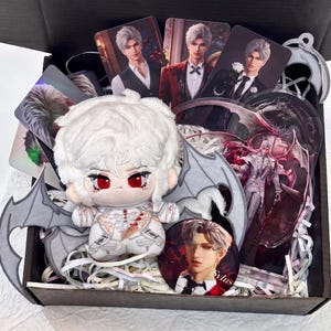 May include: A plush doll with white hair and red eyes, wearing a white outfit with gray wings, accompanied by several character cards, a circular pin with the name Sylus, and an acrylic standee featuring a figure with wings in a box.