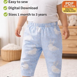 May include: A baby wearing light blue barrel leg pants with a white bunny pattern. The image includes text that says "Barrel Leg Pant Sewing Pattern", "Easy to sew", "Digital Download", and "Sizes 1 month to 3 years".