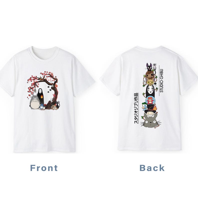 May include: White t-shirt featuring a front graphic of characters from a Japanese animated film, including a large, gray, round creature and a black figure under a tree with pink blossoms. The back has a stacked graphic of other characters and the words "STUDIO GHIBLI".