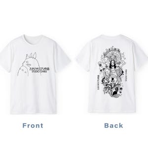 May include: White t-shirts featuring Studio Ghibli designs. The front shirt displays a Totoro illustration with Japanese text and "STUDIO GHIBLI". The back shirt has a detailed black and white graphic with Japanese text and "STUDIO GHIBLI".