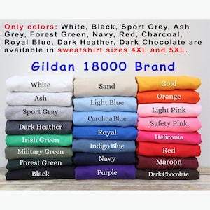 May include: A stack of Gildan 18000 brand sweatshirts in various colors, including white, black, sport grey, and forest green. The available sizes are 4XL and 5XL. The image displays the color options: Sand, Gold, Orange, and more.