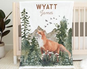 May include: A white baby blanket featuring a watercolour illustration of a fox in a woodland setting. The blanket is personalised with the name "WYATT James" printed in brown text.