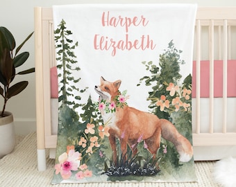 May include: A white baby blanket with a watercolor illustration of a fox in a forest setting. The blanket has the names "Harper Elizabeth" printed in pink lettering.