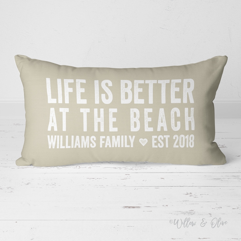20 by 14 inch personalized lumbar pillow. Life is Better at the Beach text on first two lines. Below that reads your Family last name then the word Family with Established year. Family Name Established Year separated by heart. Custom color choices