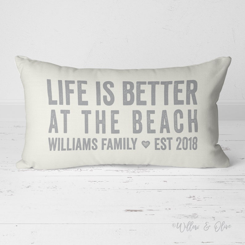 20 by 14 inch personalized lumbar pillow. Life is Better at the Beach text on first two lines. Below that reads your Family last name then the word Family with Established year. Family Name Established Year separated by heart. Custom color choices