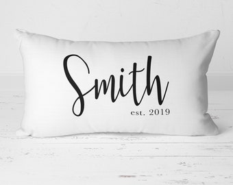 May include: White pillow with black cursive text that reads "Smith est. 2019".