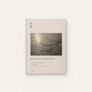 以下が含まれることがあります： 「Japanese Micro-Seasons Journal」と題されたベージュ色のジャーナル。上部には日本語の文字が書かれています。表紙には、木の枝と水面の写真が使われています。「A Quiet Journal Inspired by Japan's Seasonal Changes」と書かれています。