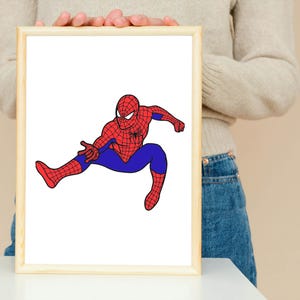 May include: A framed illustration of Spider-Man in a dynamic pose. The superhero is depicted in his classic red and blue suit, with a detailed web pattern on the red sections. The artwork is set against a white background within a light-colored wooden frame.