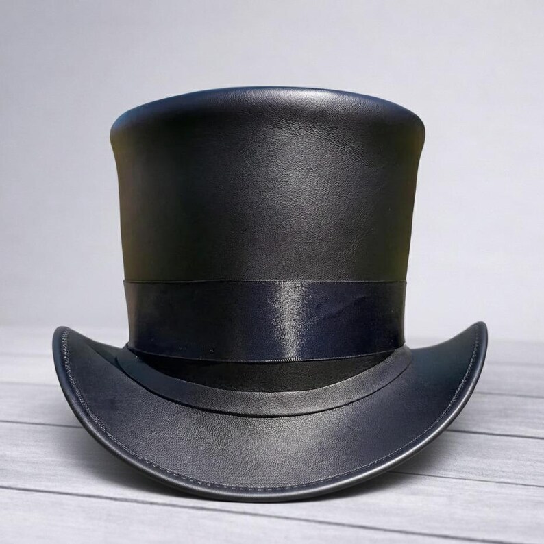 May include: A black top hat with a wide brim and a black band around the crown. The hat is made of a smooth, possibly leather, material. The hat is a classic formal accessory.