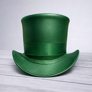 May include: A vibrant green top hat with a satin ribbon band. The hat has a curved brim and a tall, cylindrical crown. The hat is made of a smooth, shiny material.