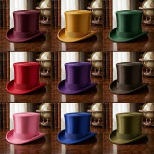 May include: Nine colorful top hats in various shades, including burgundy, gold, green, red, purple, black, pink, blue, and olive green. Each hat has a matching band and brim, displayed on a wooden surface.