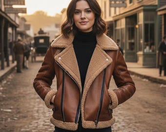 May include: A brown leather jacket with a shearling lining and collar. The jacket has a zip closure, pockets, and a classic biker style. The model is wearing a black turtleneck and dark jeans. The background shows a vintage street scene.