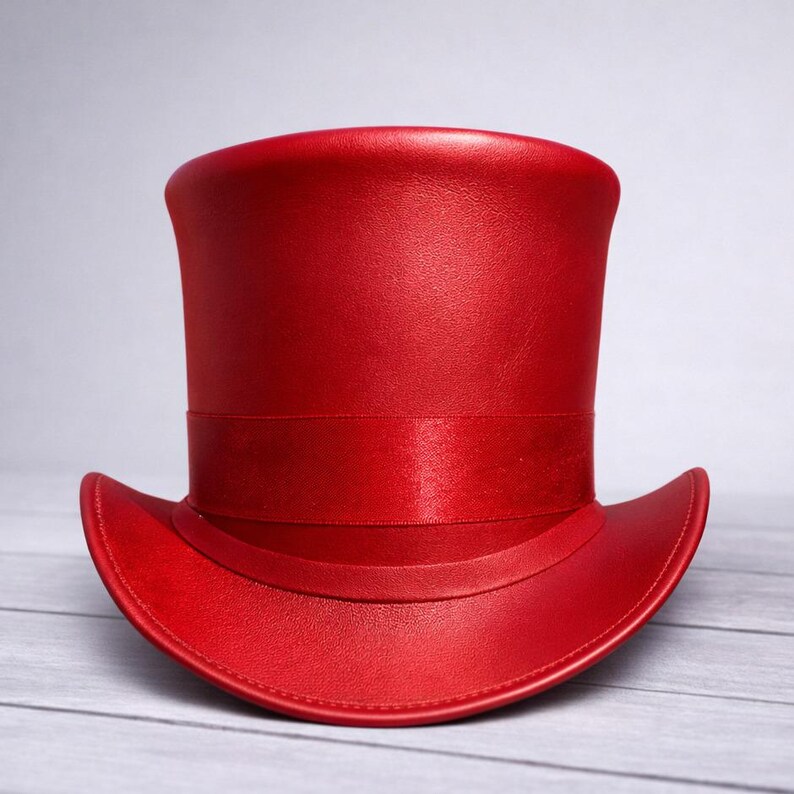 May include: A vibrant red top hat with a matching satin band. The hat has a classic tall crown and a slightly curved brim. The hat is made of a smooth, possibly leather-like material.