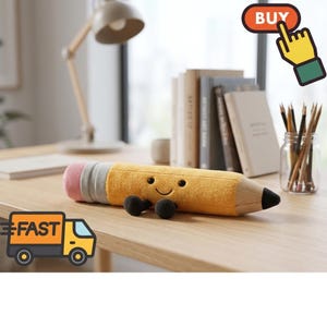 May include: A plush pencil toy with a yellow body, a pink eraser, a grey metal-colored band, and a black tip. The pencil features a stitched smiling face with two small black eyes and a curved mouth, along with two small black plush feet.