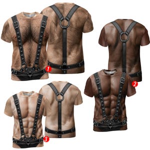 May include: A collection of short-sleeved t-shirts featuring realistic 3D prints of muscular torsos with varying skin tones and hair levels. Each shirt displays a graphic of a black leather-style harness with metal buckles, studs, and rings.