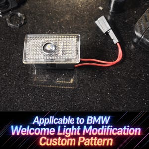 May include: A clear, rectangular LED light with a textured surface and a central light source. Red wires extend from the black base. The text at the bottom reads "Applicable to BMW Welcome Light Modification Custom Pattern."
