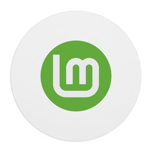 May include: A circular white sticker featuring a solid green circle in the center. Inside the green circle is a stylized white letter L and a lowercase m connected together, forming the Linux Mint logo on a clean, minimalist background.