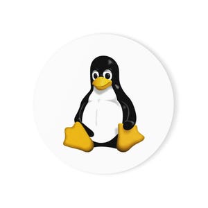 May include: A circular sticker featuring a graphic illustration of a penguin with a black head and back, a white belly, and a yellow beak and feet. The penguin is depicted in a seated position against a solid white background, centered on the sticker.