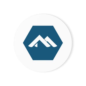 May include: A circular white sticker featuring a dark blue hexagon in the centre. Inside the hexagon is a white graphic icon consisting of two overlapping mountain-like shapes with pointed peaks, creating a stylised letter M design.