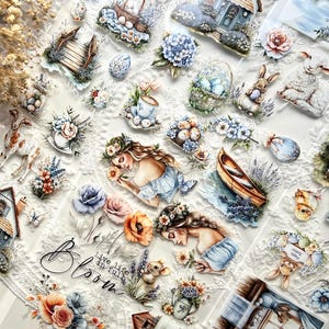 Puede incluir: Una colección de pegatinas decorativas con temática de primavera y Pascua. Las pegatinas presentan ilustraciones de flores, conejos, huevos, casas y mujeres. La paleta de colores incluye azules pastel, rosas y naranjas, con un fondo de encaje blanco.