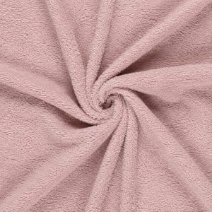 May include: A dusty rose pink towel featuring a dense, looped terry cloth texture. The fabric is arranged in a central spiral pattern, showcasing the soft, absorbent pile of the material with consistent color throughout the entire surface area.
