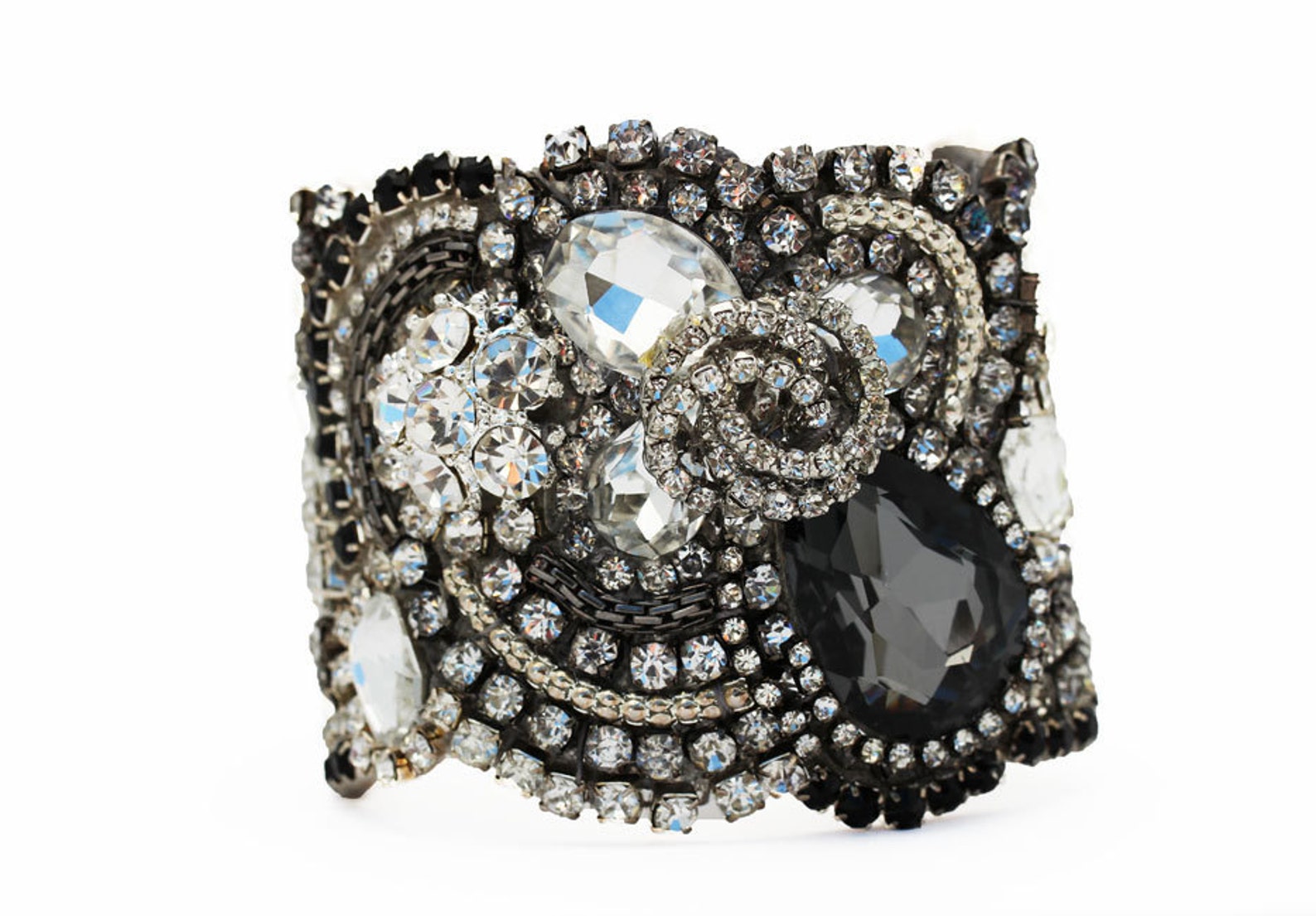 Close-up of Swarovski crystal cuff with baroque scroll and teardrop embellishments
