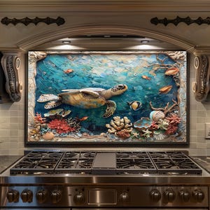May include: A large, framed artwork depicting an underwater scene with a sea turtle, fish, coral, and seashells. The artwork features a textured, painted style with shades of blue, green, orange, and brown. The artwork is mounted above a stainless steel gas range.