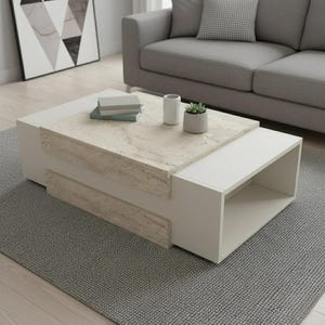 Puede incluir: Una mesa de centro moderna de dos tonos. Presenta una superficie clara con aspecto de piedra y una base blanca con un estante incorporado. Libros, una pequeña planta y un jarrón blanco decoran la mesa.