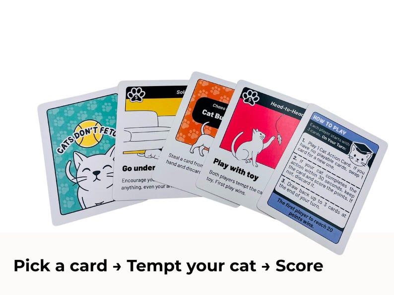 May include: A set of five playing cards from the game Cats Don't Fetch. The cards feature illustrations of cats, paw print patterns, and text including instructions like Go under, Cat Burglar, Play with toy, and a How to Play card with rules.