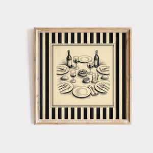 May include: Square framed print featuring a detailed black and white illustration of a dining table set for a meal. The table setting includes plates, silverware, wine glasses, and bottles, with a striped border.