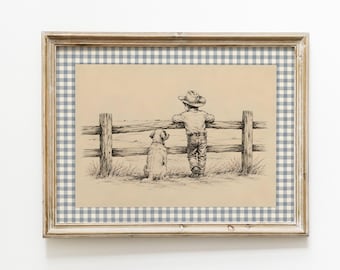 May include: A framed art print featuring a black and white ink drawing of a person in a cowboy hat and a dog standing side by side, leaning against a wooden fence. The print is set against a blue and white gingham patterned matting.