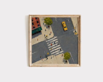 May include: A square framed oil painting depicting an aerial view of a city street intersection. A yellow taxi drives on gray asphalt near a white crosswalk. Pedestrians walk on beige sidewalks beside a red brick building with a green awning.