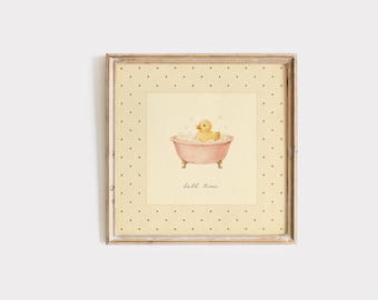 May include: A square framed wall art print featuring a yellow rubber duck in a pink clawfoot bathtub filled with bubbles. The background is a pale cream color with a dark brown polka dot border. The text "bath time" is written in cursive below.