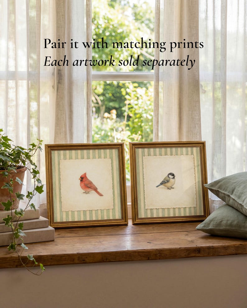May include: Two framed bird prints with gold frames. One features a red cardinal, the other a small bird. The artwork is set against a striped background. The text on the image says, "Pair it with matching prints. Each artwork sold separately."